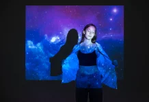 young-woman-standing-universe-texture-projection_23-2149512066